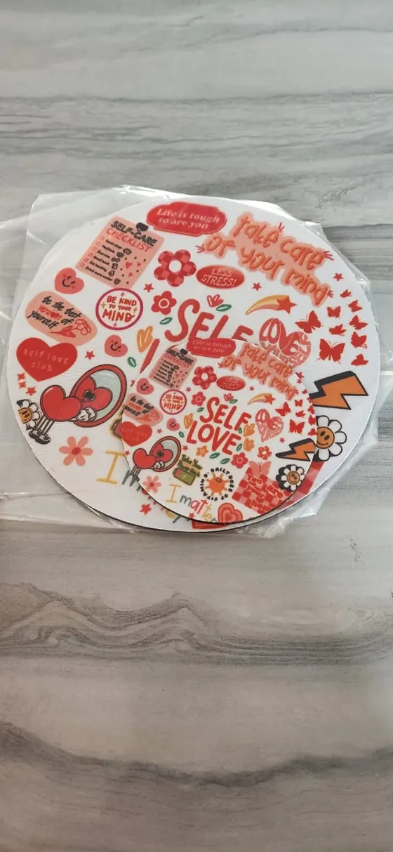 Round self-love sticker sheet printed with hearts, flowers and affirmation words
