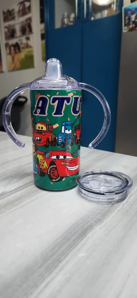 Kids sippy cup with two handles printed with cartoon racing cars and a truck