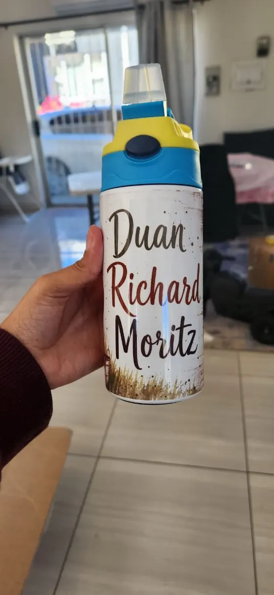Kids flip-top bottle printed with the name Duan Richard Moritz over a wheat field